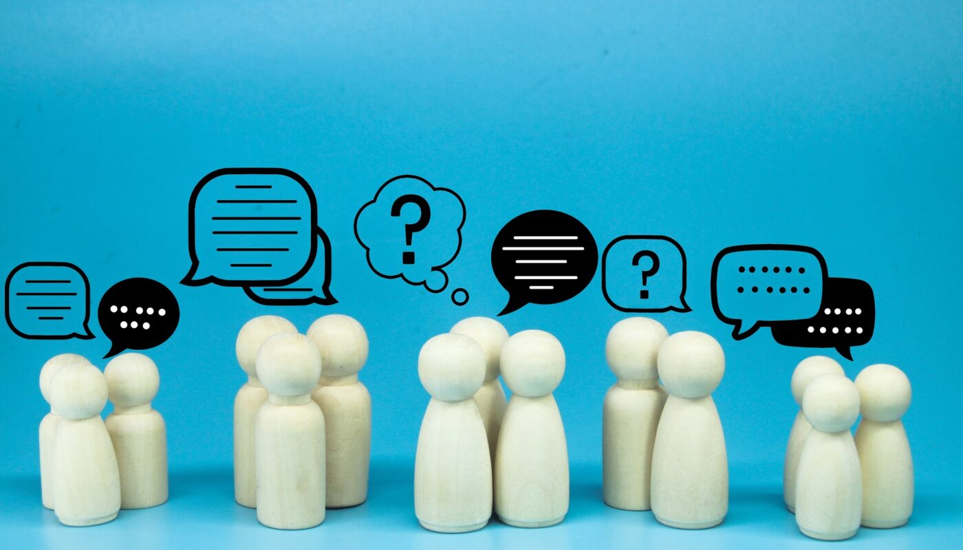 peg doll with message notification icon, chat social media interaction.
